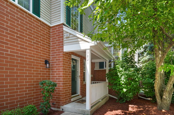 Front view of a house with brick exterior and a small porch.
