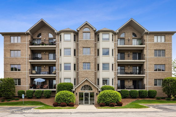 Front view of a multi-story residential building with balconies.