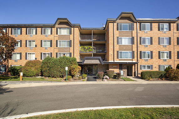 Front view of a multi-story brick apartment building.