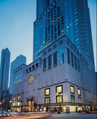 Front view of a tall multi-story building with large windows and architectural detailing.