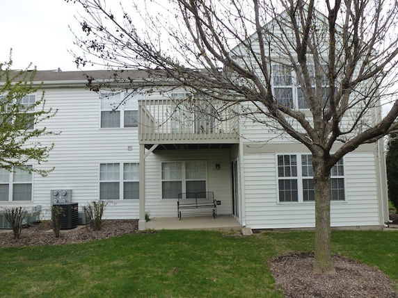 Front view of a two-story house with a small balcony.