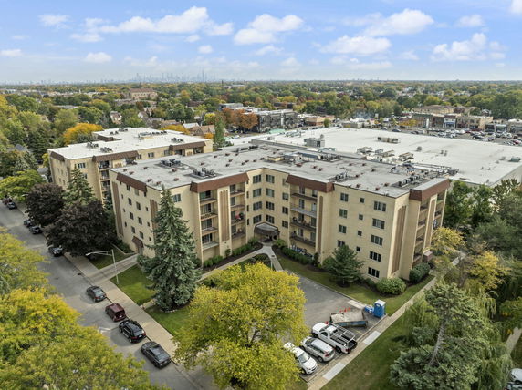 Front view of a multi-story apartment building with balconies.