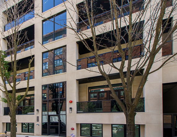 Front view of a multi-story building with large windows and balconies.