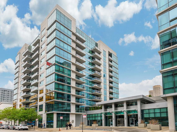 Front view of a modern multi-story building with glass façade.