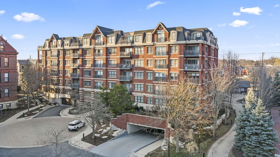 Front view of a multi-story brick building with balconies.