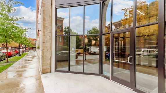 Front view of a building with large glass windows and entrance.