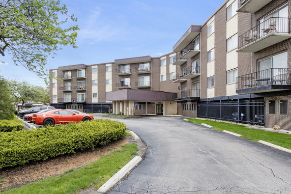 Front view of a multi-story residential building with balconies.