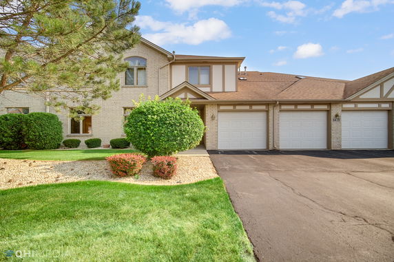 Front view of a two-story house with a garage.