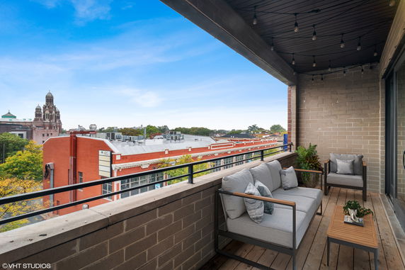Balcony view overlooking surrounding buildings and skyline.
