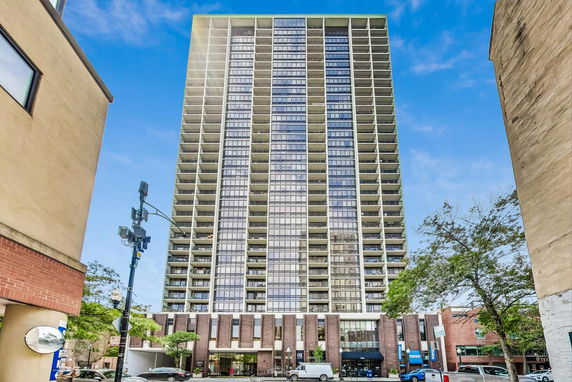 Front view of a high-rise building with multiple balconies.