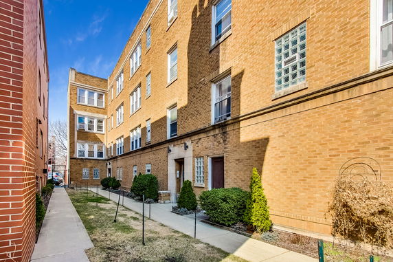 Front view of a multi-story brick building.