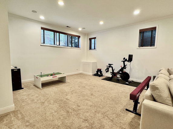 Indoor play area with exercise equipment and a play table.
