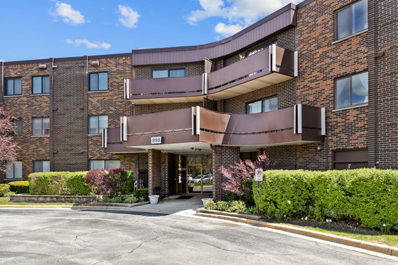 Front view of a multi-story brick building with balconies.