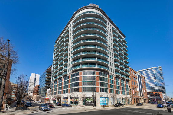 Front view of a multi-story residential building with balconies.