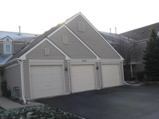 Front view of a house with a triple garage.