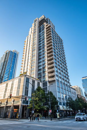 Front view of a multi-story residential building with balconies.