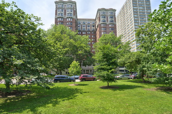 Front view of a multi-story residential building with decorative architectural features.