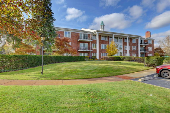 Front view of a multi-story brick building with balconies.