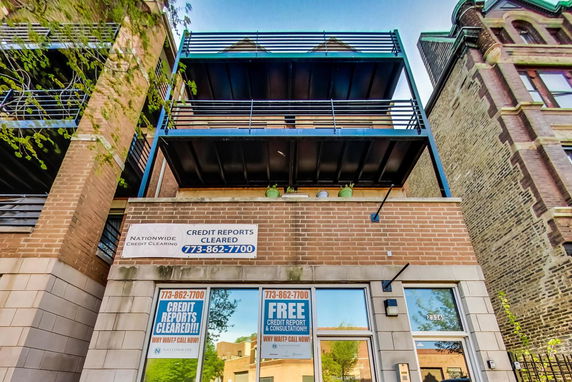 Front view of a multi-story building with signage indicating credit report services.