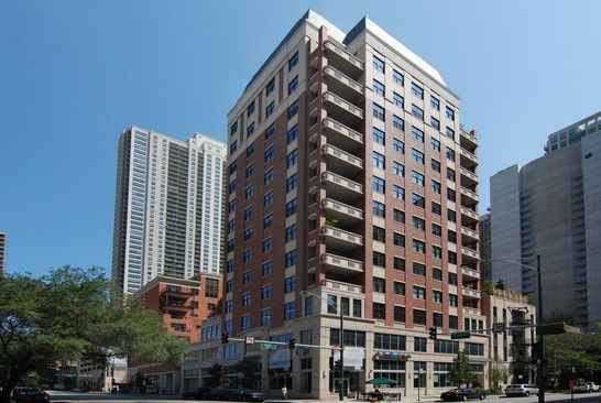 Front view of a multi-story building with balconies on each floor.