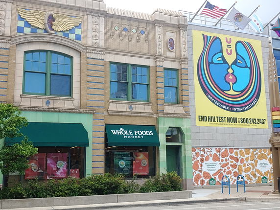 Front view of a building with a Whole Foods Market storefront and colorful wall art.