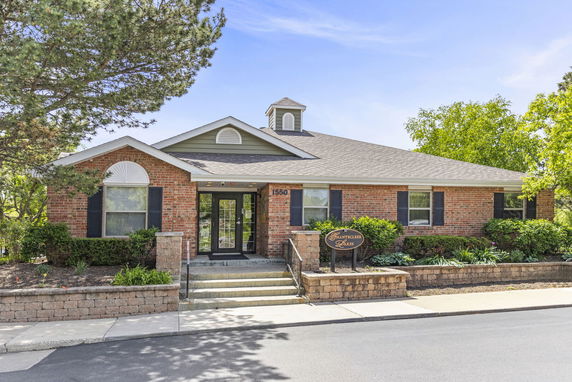 Front view of a single-story brick building with a gabled roof and entrance steps.