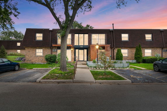 Front view of a two-story building with a central entrance and a brick exterior.