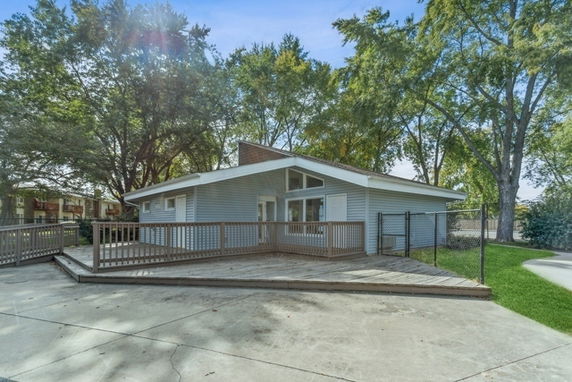 Front view of a single-story house with a large deck.