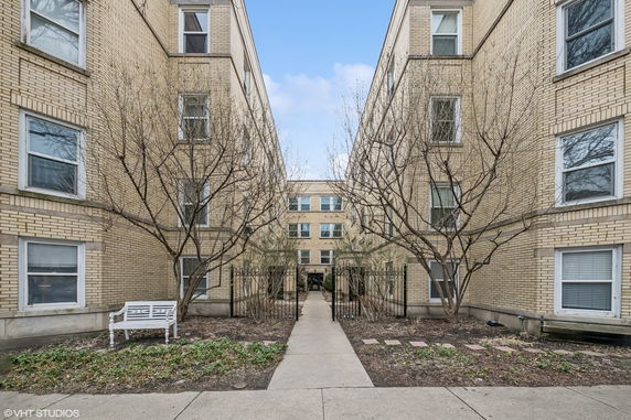 Front view of a multi-story brick apartment building.