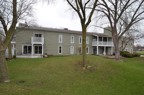 Rear view of a two-story residential building with balconies.
