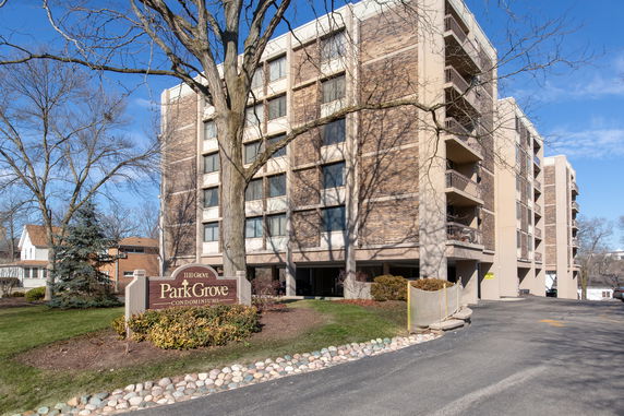 Front view of a multi-story condominium building with balconies.