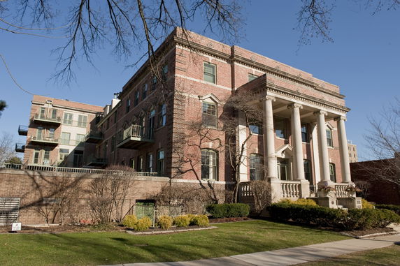 Front view of a large brick building with columns.