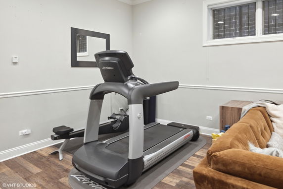 Indoor room with treadmill and sofa.
