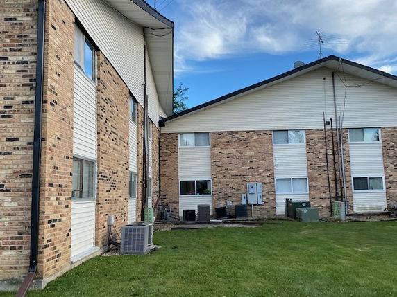 Side view of a multi-story brick apartment building.