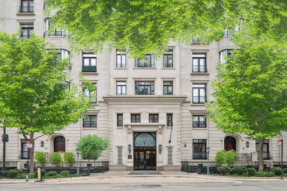 Front view of a multi-story building with ornate entrance and multiple windows.