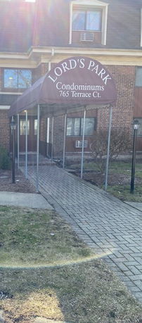 Front view of a condominium building with an entrance canopy.