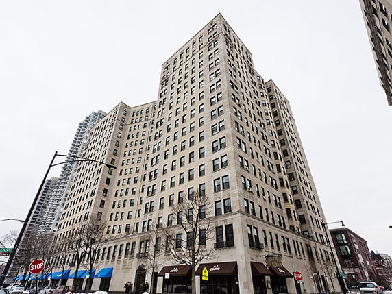 Front view of a multi-story building with a retail area on the ground floor.