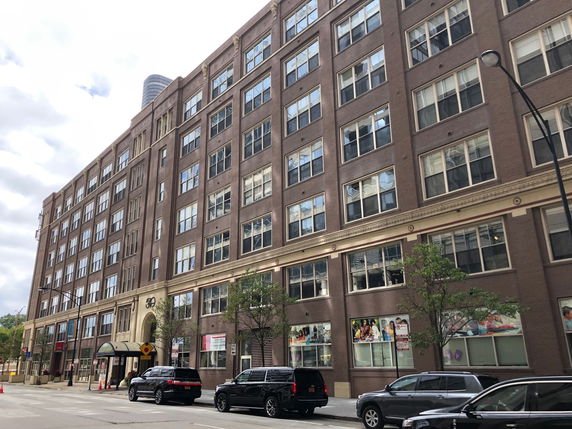Front view of a large multi-story brick building.
