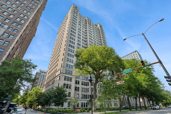 Front view of a tall residential building with multiple floors.
