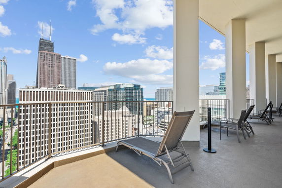 Panoramic view of urban skyline from a high-rise building balcony.