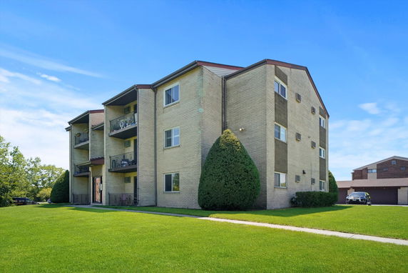Front view of a multi-story residential building with balconies.