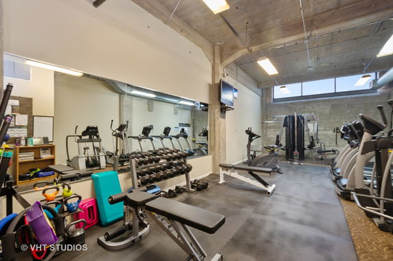 Indoor gym area with various exercise equipment.