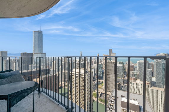 Wide angle view of a city skyline from a high-rise balcony.