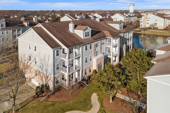 Front view of a multi-story residential building with balconies.