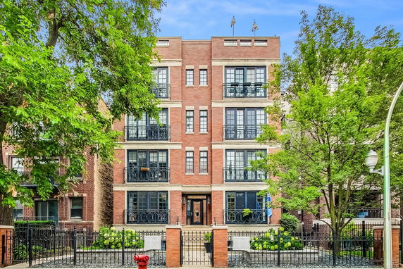 Front view of a multi-story brick building with balconies.