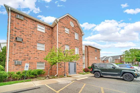 Front view of a three-story brick apartment building.
