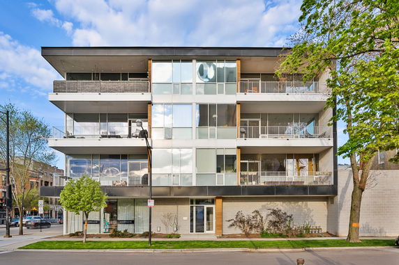 Front view of a modern multi-story building with balconies.
