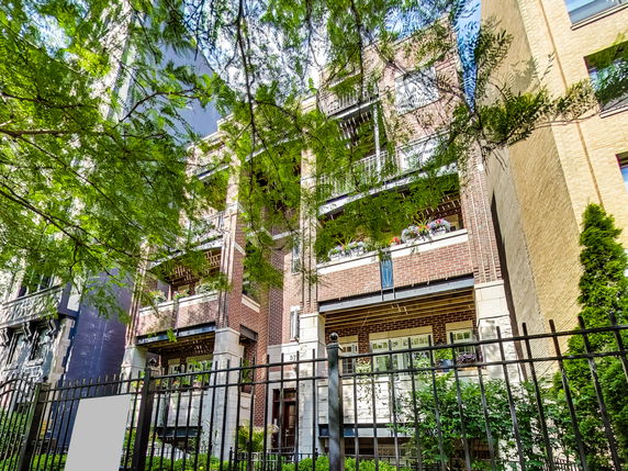 Front view of a multi-story brick residential building.