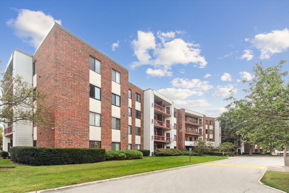 Front view of a multi-story brick apartment building.