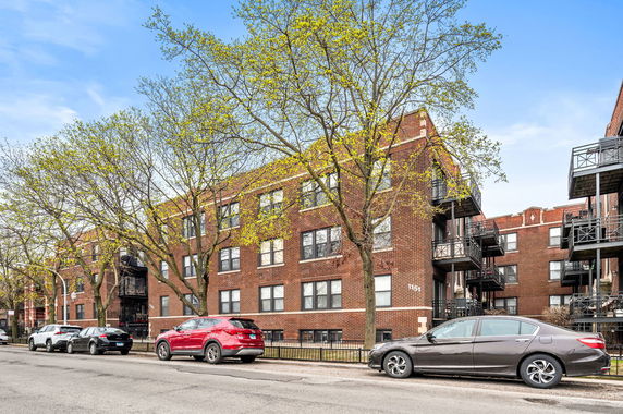 Front view of a multi-story brick apartment building.